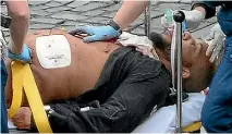 ??  ?? Khalid Masood receives medical attention after being shot by police following his deadly rampage at Westminste­r Bridge and the Houses of Parliament.