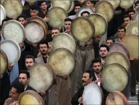  ?? VAHID SALEMI / AP ?? Musicians from Iran’s Kurdish region play a hand-held Persian drum known as the daf at a park in Teheran on March 14. They were taking part in a ceremony ahead of the Iranian New Year, which is also called Nowruz.
