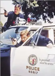  ?? Silver Screen Collection/Getty Images ?? KENT McCORD, top, and Martin Milner in costume as LAPD Officers Reed and Malloy circa 1972.