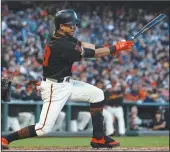  ?? JASON O. WATSON/GETTY IMAGES/TNS ?? Mauricio Dubon of the Giants hits a single against the Miami Marlins on September 14, 2019 in San Francisco.