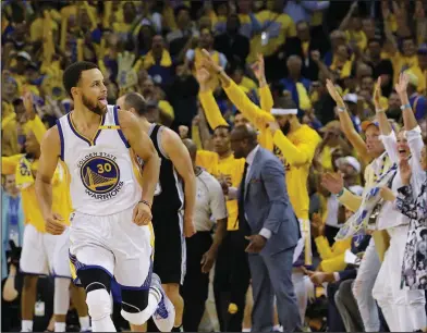  ?? Associated Press ?? Golden boy: Golden State Warriors guard Stephen Curry (30) reacts after scoring against the San Antonio Spurs during the second half Sunday in Oakland, Calif., Sunday. The Warriors won 113-111.