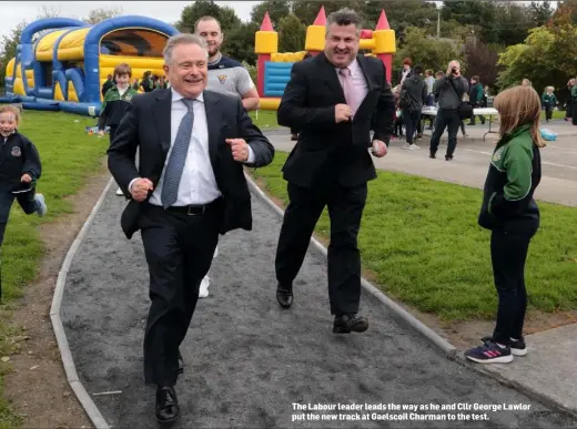  ??  ?? The Labour leader leads the way as he and Cllr George Lawlor put the new track at Gaelscoil Charman to the test.