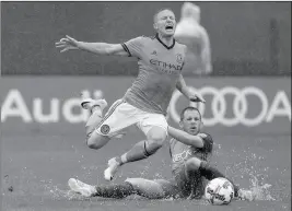  ?? ASSOCIATED PRESS ?? New York City FC midfielder Alexander Ring (left) is tripped up by Seattle Sounders forward Harrison Shipp during the second half Saturday in New York. NYCFC won 2-1.