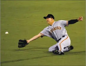  ?? MARK J. TERRILL – THE ASSOCIATED PRESS ?? Giants right fielder Joe McCarthy can’t get to a ball hit for a double by the Dodgers’ Justin Turner during the eighth inning of Thursday night’s season-opening loss in Los Angeles.