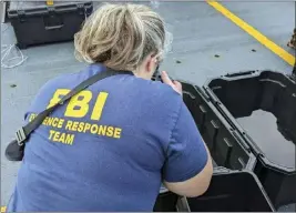  ?? FBI — FOR THE ASSOCIATED PRESS ?? In this undated photo, an FBI evidence response team photograph­er takes pictures of material recovered from the chinese high altitude balloon shot down off the coast of Myrtle Beach, S.C.