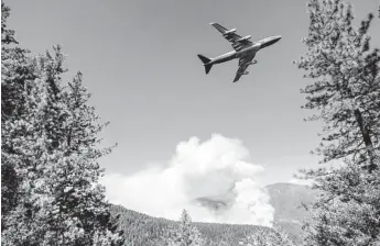  ?? NOAH BERGER AP ?? An air tanker prepares to drop retardant while battling the August Complex fire in the Mendocino National Forest. That fire, which ignited Aug. 16, was 870,200 acres and 43 percent contained Saturday.