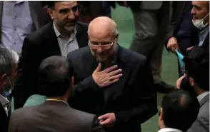  ??  ?? Iranian Mohamed Bagher Ghalibaf (centre) stands among members of the parliament after being elected as parliament speaker at the Iranian parliament in Tehran yesterday.