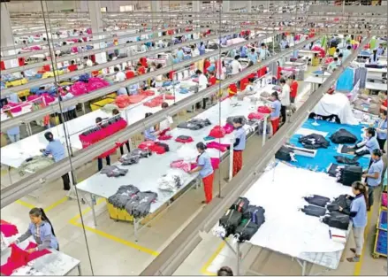  ?? FILE PHOTO ?? Garment workers at an apparel factory in the Phnom Penh Special Economic Zone.