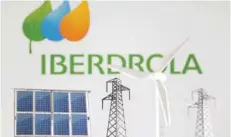  ?? — Reuters ?? Miniatures of windmill, solar panel and electric pole are seen in front of Iberdrola Renewables logo in this illustrati­on.