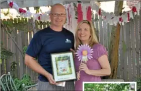  ??  ?? Don and Kathy Zebrauskas hold the plaque they earned from winning first place in the multicultu­ral garden category in Souderton Borough’s 125th anniversar­y garden decorating contest.