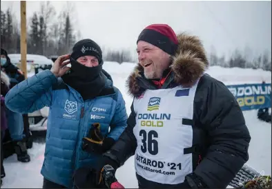  ??  ?? CONGRATULA­TIONS— Iditarod champion Dallas Seavey, left, congratula­tes runner-up Aaron Burmeister for a race well run, on Monday, March 15 at Deshka Landing.