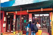  ??  ?? An acid attack survivor helps customers at Sheroes Hangout in Agra, India.