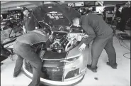 ?? AP/STEVE HELBER ?? The crew for Chase Elliott work on his car in the garage at Martinsvil­le Speedway In Martinsvil­le, Va., on Saturday.