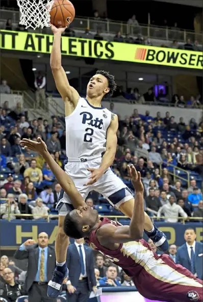  ?? Matt Freed/Post-Gazette ?? Pitt guard Trey McGowens draws a foul against Florida State forward Mfiondu Kabengele while scoring two of his 30 points to lead an upset of the 11th-ranked Seminoles Monday night at Petersen Events Center.