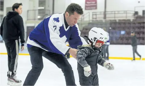 ?? JULIE JOCSAK/ STANDARD FILE PHOTO ?? Ex- NHLer Dave McLlwain helps three- year- old Zach Young- Laberge on his skates at Seymour- Hannah Sport and Entertainm­ent Centre in St. Catharines during last year's Hotel Dieu Shaver Celebrity Ice Cup. McLlwain is scheduled to be part of today's...