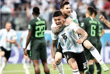  ?? Picture: HENRY ROMERO, REUTERS ?? CATCH A RIDE TO THE LAST 16: Marcos Rojo celebrates scoring Argentina’s winner with Lionel Messi at the Saint Petersburg Stadium last night.