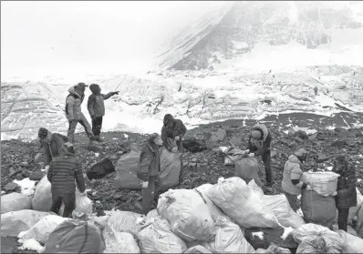  ?? AWANG ZHAXI / XINHUA ?? People collect garbage at the north slope of Qomolangma in Southwest China’s Tibet autonomous region on May 8. Nepal has also launched a campaign to clean the mountain’s southern side.
