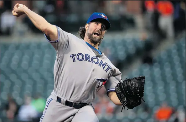  ?? — GETTY IMAGES ?? Toronto Blue Jays starter R.A. Dickey delivers a pitch in the first inning at Camden Yards Monday in Baltimore during the host Orioles 4-3 extra-innings victory. Dickey gave up three runs in the first, but recovered to post a quality start in his six...