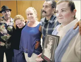  ?? Al Seib Los Angeles Times ?? SHERRI NELSON, with family members of other victims, holds a photo of her sister Audrey, 35, after Sam Little’s sentencing hearing in Los Angeles in 2014.