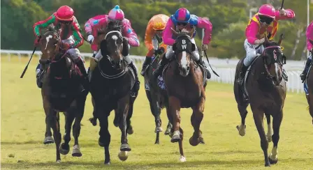  ?? CLOSE ONE: Valuate with jockey Chris Whitely ( far left) wins the Two- Year- Old Classic Prelude Handicap at Cluden Park yesterday. ??