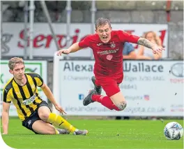  ??  ?? Brora Rangers’ Kyle Macleod is brought down by Nairn County’s Liam Shewan