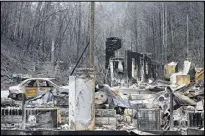  ??  ?? Destroyed homes near the downtown area of Gatlinburg, Tenn., are shown Monday. A week ago on Monday, fires killed 14 people and damaged or destroyed almost 1,700 buildings in the region.