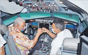  ?? Picture: BALJEET SINGH ?? Prime Minister Voreqe Bainimaram­a with Captain Vimlesh Rao inside the 737 MAX flight simulator after the opening of the Fiji Airways Aviation Academy in Nadi this week.