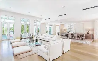  ?? DOUGLAS ELLIMAN REAL ESTATE/COURTESY ?? The open floor plan features minimalist interiors, with white surfaces and textures and light wood floors.