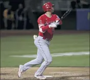  ??  ?? The Angels’ Shohei Ohtani watches his solo home run against the Athletics during the eighth innin in Oakland on Tuesday. The Angels lost 6-4.