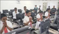  ??  ?? Pupils of Natest Primary School give thanks for a computer donation, which they see as a symbol of love and ubuntu. At the back of the classroom are, from left, principal Mac Thilakdhar­i, N Naicker (head of department), Tad Dorasamy and Dennis Munsamy.