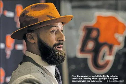  ??  ?? New Lions quarterbac­k Mike Reilly talks to media on Tuesday after signing a four-year contract with the B.C. Lions. — THE CANADIAN PRESS