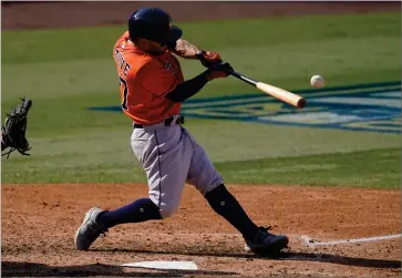  ?? ASSOCIATED PRESS ?? Houston Astros’ Jose Altuve hits a two-run single against the Oakland Athletics during the sixth inning of Game 1 of a baseball American League Division Series in Los Angeles, Monday, Oct. 5, 2020.