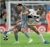  ??  ?? Michael Boxall and Zlatan Ibrahimovi­c fight for possession during an MLS match. While in Minnesota, Boxall occasional­ly got courtside tickets to watch NBA superstar LeBron James, above, in action.