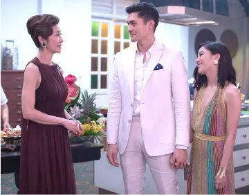  ??  ?? (From left) Tan Sri Michelle Yeoh, Henry Golding and Constance Wu flaunting luxury apparel in ‘Crazy Rich Asians.’ — Photo courtesy of Warner Bros. Pictures