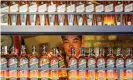  ?? Photograph: Shamil Zhumatov/Reuters ?? A bartender takes a bottle of Johnnie Walker whisky. Scotch accounts for a quarter of Diageo’s net sales.