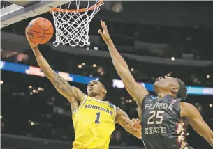  ?? JAE HONG/THE ASSOCIATED PRESS ?? Michigan guard Charles Matthews, right, shoots against Florida State forward Mfiondu Kabengele on Saturday in the NCAA Tournament in Los Angeles.