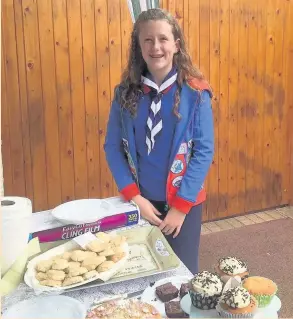  ?? ISOBEL Cutts, a 13 year-old Girl Guide from Southport, is following in her grandmothe­r’s footsteps and has raised £470 for North West Cancer Research. Isobel turned her front drive into a cake stall selling hundreds of cakes to raise money for the charity ??