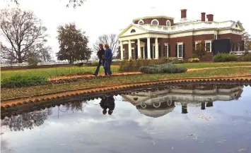  ?? — WP-Bloomberg photos ?? Visitors who toured Thomas Jefferson’s Monticello Mansion walk past a reflecting pond in the Mansion’s front yard.