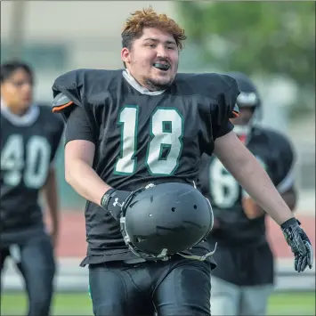  ??  ?? Perris High lineman Robert Barrios skips with a smile on his face to his next drill, thrilled to be back on the field. Perris is able to practice and play football games again after coronaviru­s pandemic issues prevented it from doing so in the spring.