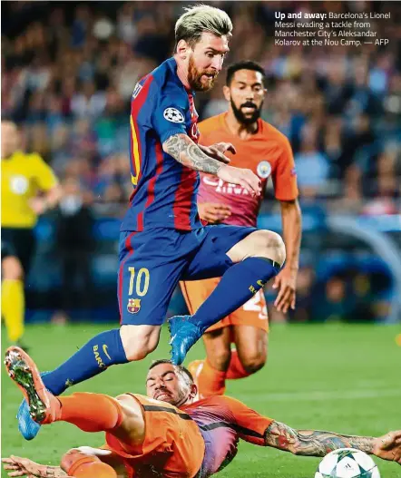  ??  ?? Up and away: Barcelona’s Lionel Messi evading a tackle from Manchester City’s Aleksandar Kolarov at the Nou Camp. — AFP