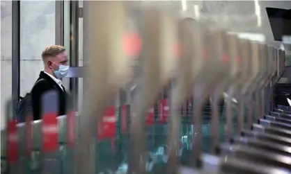  ?? Kolesnikov­a/AFP/Getty Images ?? A passenger walks through a ticket gate equipped with Face Pay at Turgenevsk­aya metro station in Moscow. Photograph: Natalia