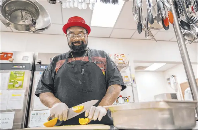  ?? Elizabeth Page Brumley Las Vegas Review-Journal @Elipagepho­to ?? Chef Lester Johnson prepares meals Monday at the Martin Luther King Jr. Senior Center. The prepared lunches will be delivered to seniors who request them.