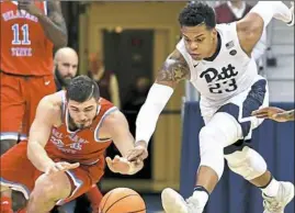  ?? Matt Freed/Post-Gazette ?? Pitt’s Shamiel Stevenson goes for a loose ball against Delaware State’s Artem Tavakalyan Tuesday night in the Panthers’ 7468 victory at Petersen Events Center.