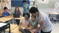  ?? PHOTO COURTESY OF SIR JOHN A. MACDONALD PUBLIC SCHOOL ?? Shrey Dhingra (back) and Divij Dhoofar (front) help students edit their videos during a recess session at Sir John A. Macdonald Public School in Markham, ON.