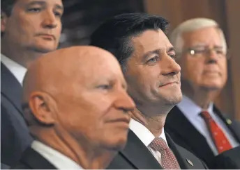  ?? ALEX WONG, GETTY IMAGES ?? Rep. Kevin Brady, R- Texas, front left, and House Speaker Paul Ryan, R- Wis., center right, take part in a press event on tax reform last month at the Capitol. The two are critical to passing such legislatio­n.