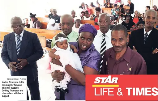  ?? GEORGE HENRY PHOTOS ?? Nadine Thompson holds her daughter Nahaliah, while her husband Godfrey Thompson and others stand with her in support.