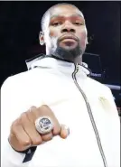  ?? (Photo by Andrew D. Bernstein/NBAE via Getty Images) ?? Kevin Durant #35 of the Golden State Warriors shows off his 2018 NBA Finals Championsh­ip ring on October 16, 2018 at ORACLE Arena in Oakland, California.