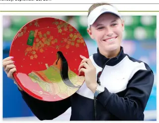  ??  ?? Caroline Wozniacki of Denmark poses with the winner’s plate after beating Anastasia Pavlyuchen­kova of Russia at the Pan Pacific Open tennis tournament in Tokyo Sunday. (AP)