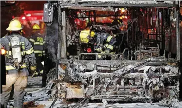  ??  ?? FIREFIGHTE­RS examine a bus in the town of Holon, near Tel Aviv, that was hit by rockets fired from Gaza. | AFP