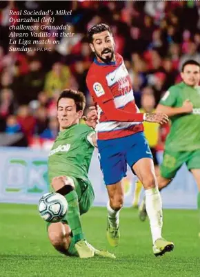  ?? EPA PIC ?? Real Sociedad’s Mikel Oyarzabal (left) challenges Granada’s Alvaro Vadillo in their La Liga match on Sunday.